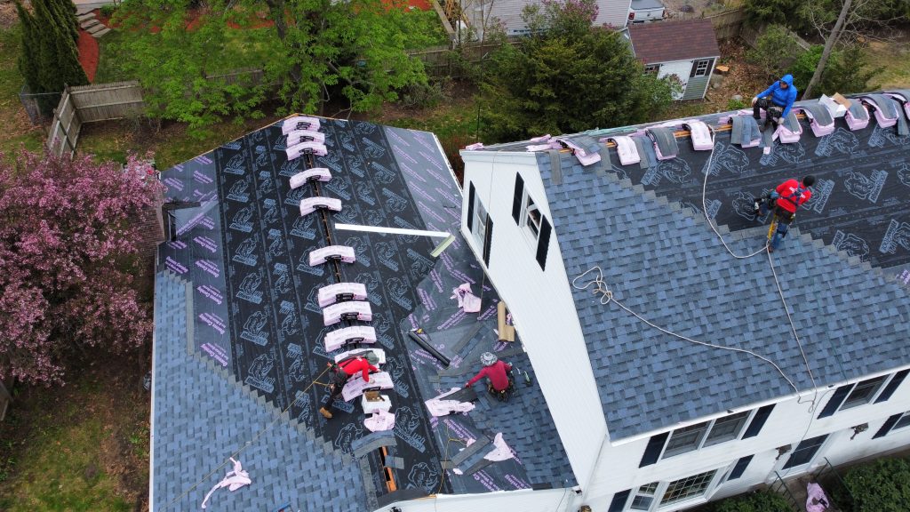Roofers working on installing in londonderry nh