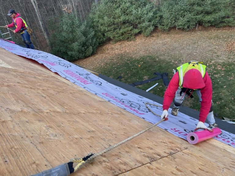 Installing synthetic underlayment over roof decking
